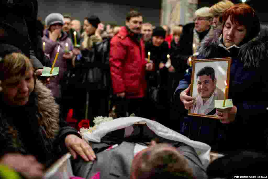 Mourners attend memorial services for five rescue workers and a miner killed in one of a series of mine explosions in Vorkuta.