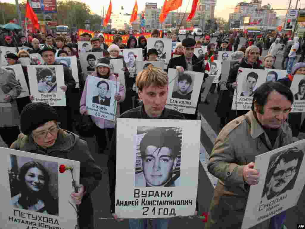 Russian Communist Party supporters march to commemorate those killed in the 1993 clashes in Moscow on October 4, the 17th anniversary of the bloody showdown between President Boris Yeltsin and parliament, which ended in a tank assault on the rebels' headquarters. Photo by Aleksei Sazonov for AFP