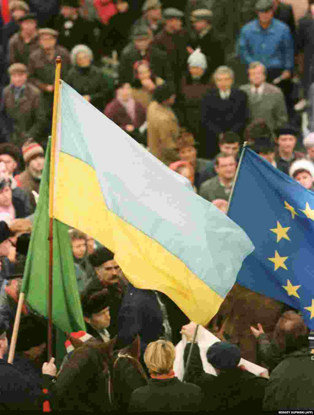 Both Ukrainian and European flags are seen during a pro-independence rally in Kyiv. &nbsp;