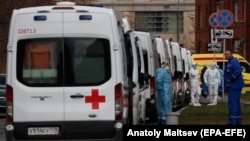 Emergency paramedics wait near ambulances at the Pokrovskaya hospital in St. Petersburg.
