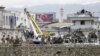 Afghan security forces inspect the site of suicide car bomb attack on a government security building in Kabul, on April 19.