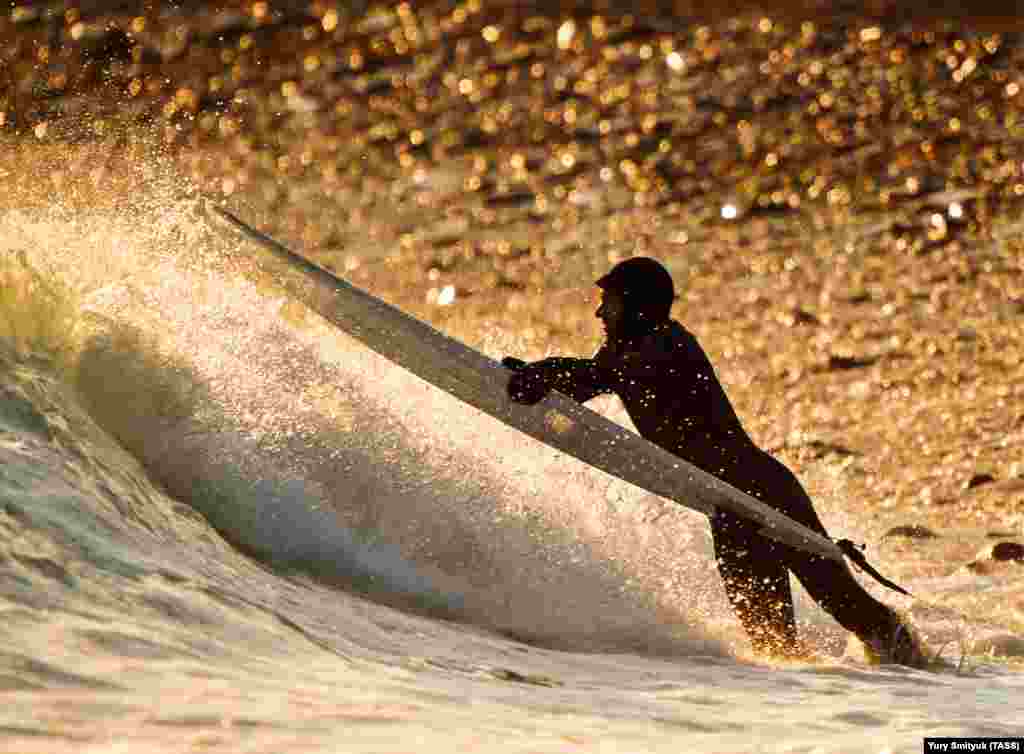 A man surfs on Russky Island near Vladivostok, Russia. (TASS)