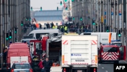 Belgian police and emergency staff arrive in the Wetstraat - Rue de la Loi, which has been evacuated after an explosion at the Maelbeek metro station in Brussels.