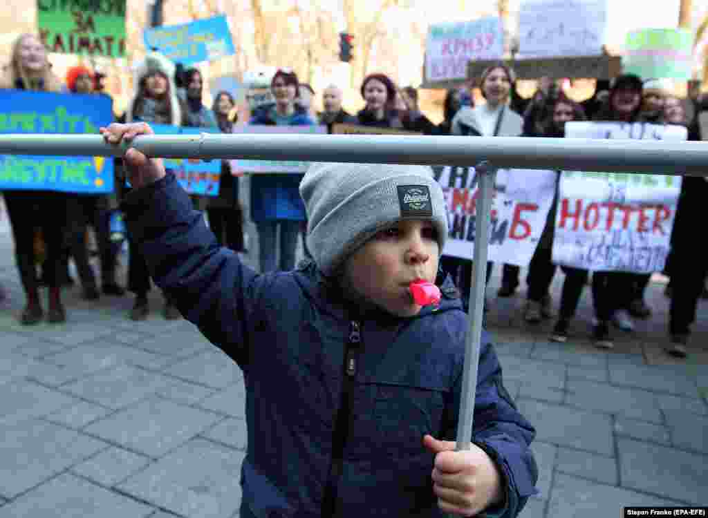 A child blows a whistle during the Global Climate Strike for the Future protest, in front the cabinet of ministers building in Kyiv on March 15. ( epa-EFE/Stepan Franko)