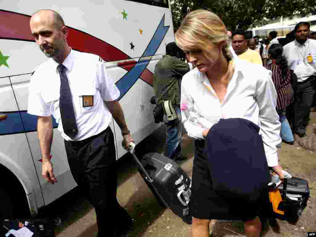 Flight attendants are released from the Trident Hotel in Mumbai on November 28.