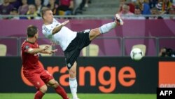 Një aksionin i futbollistit gjerman Podolski në takimin me Portugalinë