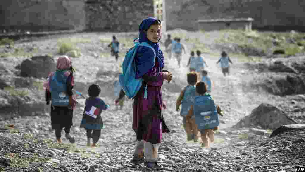 Afghan children on their way to school in a village on the road to Naghlu, which houses a French Army base, on September 24. (AFP/Jeff Pachoud)