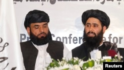 Muhammad Naeem (right), a spokesman for the Office of the Taliban of Afghanistan, speaks during the opening of the Taliban Afghanistan Political Office in Doha on June 18.