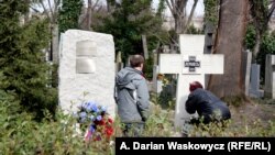 The now-removed plaque (left) is seen on March 18 next to a memorial in Prague's Olsany Cemetery that honors White Army veteran emigres who were defeated by the Bolshevik Red Army.