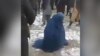 A screen grab from an amateur video of a mob beating an Afghan woman in Takhar Province because she allegedly had an extramarital affair. The woman survived the incident. 