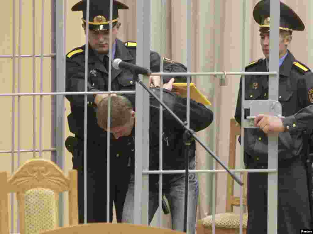 Vladislav Kovalyov is led into a holding cage before a court hearings in Minsk. Kovalyov is accused of preparing and carrying out the deadly bomb attack in the Minsk subway in April. (Photo by Vasily Fedosenko for Reuters)