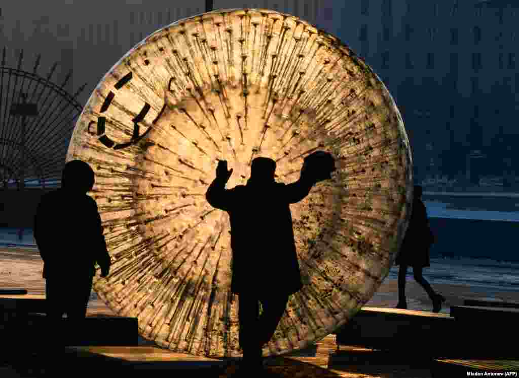 A man cleans a zorb ball outside Gorky Park at sunset in Moscow. (AFP/Mladen Antonov)