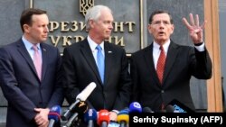 U.S. Senators Chris Murphy (left), Ron Johnson (center), and John Barrasso speak to reporters outside the presidential office following a meeting with Ukraine's president in Kyiv on February 14.