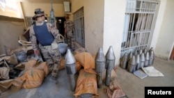 A member of the Iraqi counterterrorism forces stands by an Islamic State weapons factory in Fallujah on June 23.