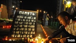 People light candles to mark the 10th anniversary of the bombing.