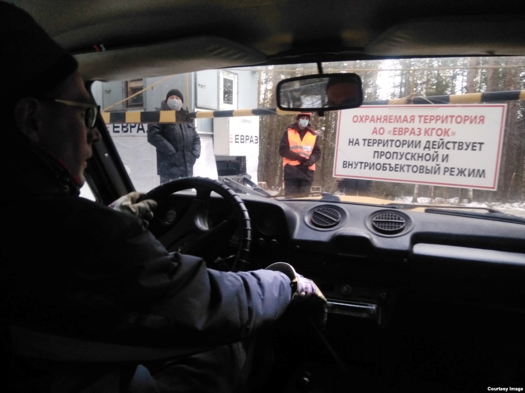 A photo from December shows a newly erected checkpoint on a road leading toward the monastery. The sign declares that the area requires a pass to enter.