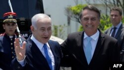 Israel's Prime Minister Benjamin Netanyahu (L) is welcomed by Brazil's President-elect Jair Bolsonaro at the Copacabana fort in Rio de Janeiro, Brazil, on December 28, 2018.