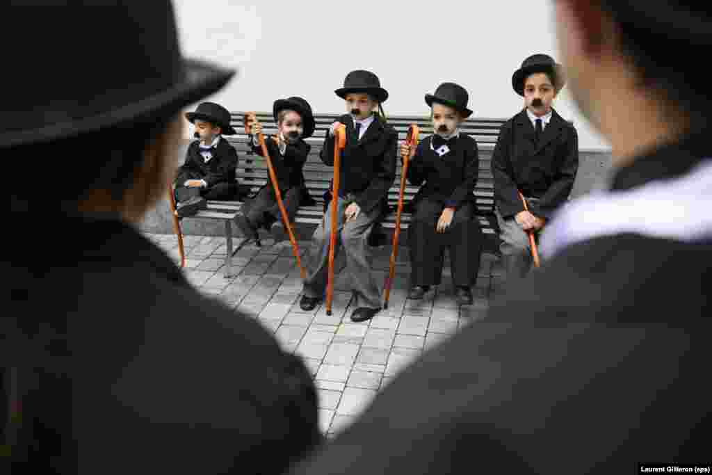 Some 662 people dressed as Charlie Chaplin pose for a group photo during an attempt to hold the world's largest gathering of people dressed as "The Tramp" in Corsier, Switzerland. (epa/Laurent Gillierion)