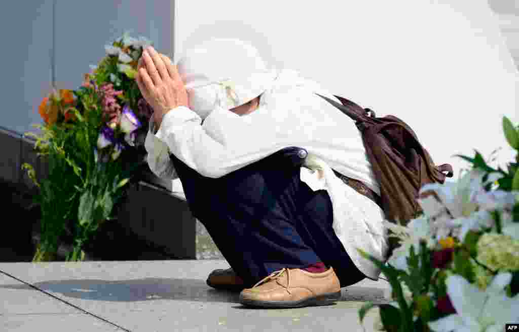 An elderly woman prays for victims of the 1945 atomic bombing of Hiroshima in front of the cenotaph at the Peace Memoral Park in Hiroshima. Hiroshima is marking the 68th anniversary of the atomic bombing on August 6. (AFP/Toru Yamanaka)