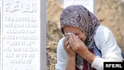 A Bosnian woman weeps over the grave of one of the victims of the Srebrenica massacre.