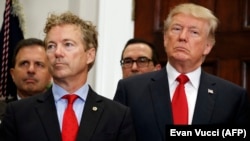 President Donald Trump stands with Sen. Rand Paul, R-Ky., during an event to sign an executive order on health care in the Roosevelt Room of the White House, Thursday, Oct. 12, 2017, in Washington.