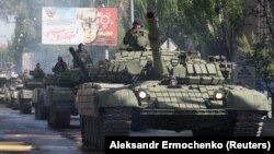 Separatist fighters in Donetsk drive banned military vehicles on May 3 in a rehearsal for the Victory Day parade.