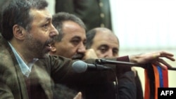 Former Foreign Minister Aleksandr Arzumanian (left) defends himself during his trial in Yerevan in December.