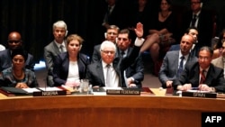 Vitaly Churkin, Russia's ambassador to the United Nations, votes to veto on a draft resolution for establishing a tribunal to prosecute those responsible for downing the MH17 flight during a UN Security Council meeting in New York in July. 