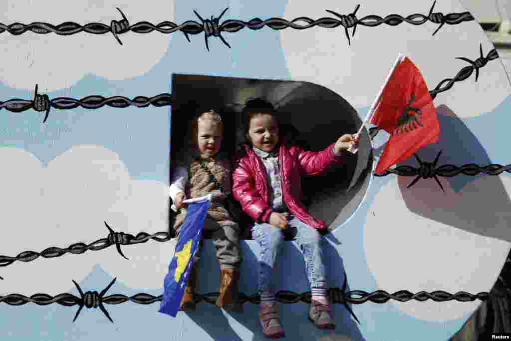 Children wave Albanian (right) and Kosovo flags during celebrations marking the eighth anniversary of Kosovo's declaration of independence from Serbia, in Pristina, on February 17. (Reuters/Marko Djurica)