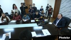 Education Minister Levon Mkrtchian (right) meets on November 8 with representatives of students protesting against government plans to scrap draft deferments.