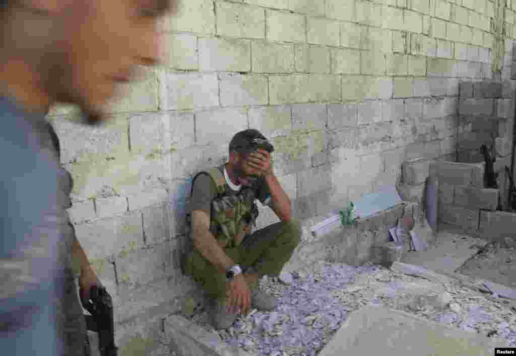 A Free Syrian Army commander reacts after his unit failed to capture a Syrian Army tank during clashes with forces loyal to President Bashar al-Assad in Aleppo's neighborhood of Salaheddine on April 29. (Reuters/Ammar Abdullah)