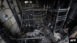 Russia -- The charred bunk beds stand inside a burned-out warehouse, the scene of a deadly fire at Kachalovsky construction market on the outskirts of Moscow, 03Apr2012