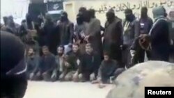 A video grab from an amateur video shows Syrian rebels sitting on the ground before their public execution by IS militants.