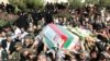 Iranians carry the coffin of General Nourali Shoushtari, one of the Revolutionary Guards commanders killed in the suicide attack claimed by Jundallah.