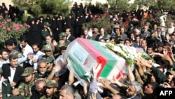 Iranians carry the coffin of General Nourali Shoushtari, one of the Revolutionary Guards commanders killed in the suicide attack claimed by Jundallah.