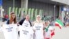 Women hold t-shirts as they protest for Iranian women's rights to enter stadiums in Iran, ahead of the FIVB Volleyball World League