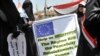 Female antiregime protesters hold a banner during a demonstration in Sanaa on April 6.