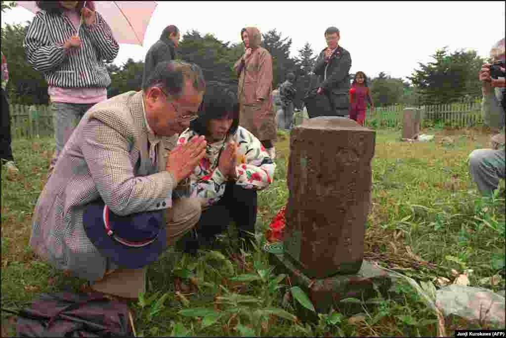 Japanese former residents visiting relatives' graves on Kunashir Island. Analysts suggest that "alpha" might include fishing rights for Japan near the two larger islands or the rights for Japanese citizens to visit and do business on the disputed islands. If Russia and Japan can find an "alpha" that is acceptable to both sides, a peace treaty can be signed and World War II might finally, formally end.