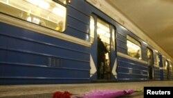 Flowers are left on the platform at the subway station in Minsk where 13 were killed.