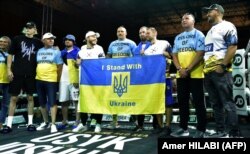 Український боксер Олександр Усик (посередині) зі своєю командою. Місто Джидда, Саудівська Аравія, 16 серпня 2022 року