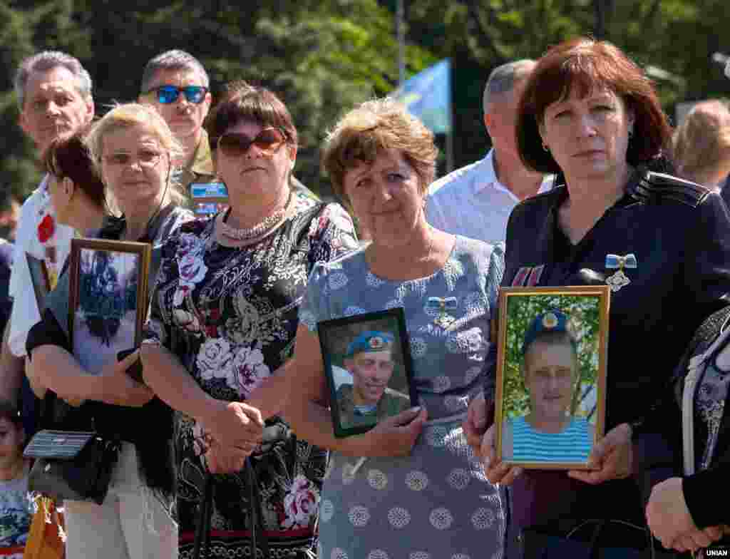 Жінки тримають портрети загиблих воїнів у нинішній війні Росії проти України. Кривий ріг