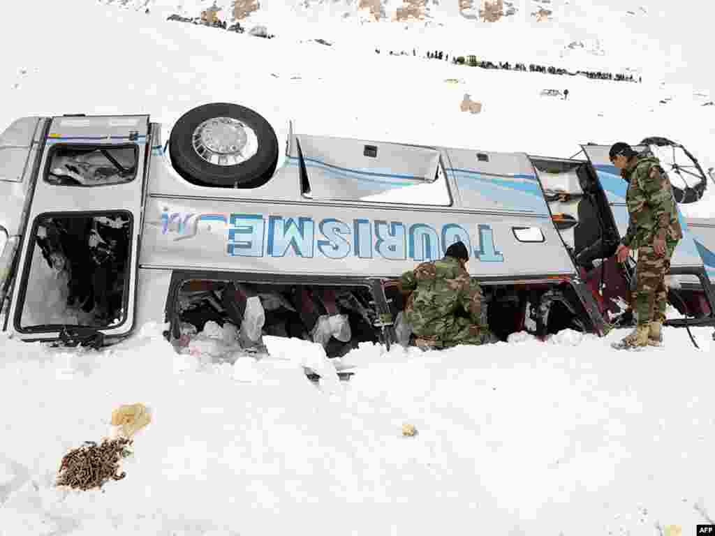 Afghan soldiers search for bodies after avalanches killed at least 165 people near the Salang Pass in Parwan Province.