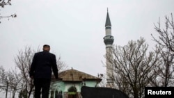 A Crimean Tatar arrives for Friday Prayers at the Khan Chair mosque in Bakhchysaray.
