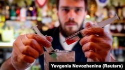 A barman stirs the newly invented Coronavirus cocktail in a bar in Moscow on March 19. "We have the situation under control," President Vladimir Putin has said.