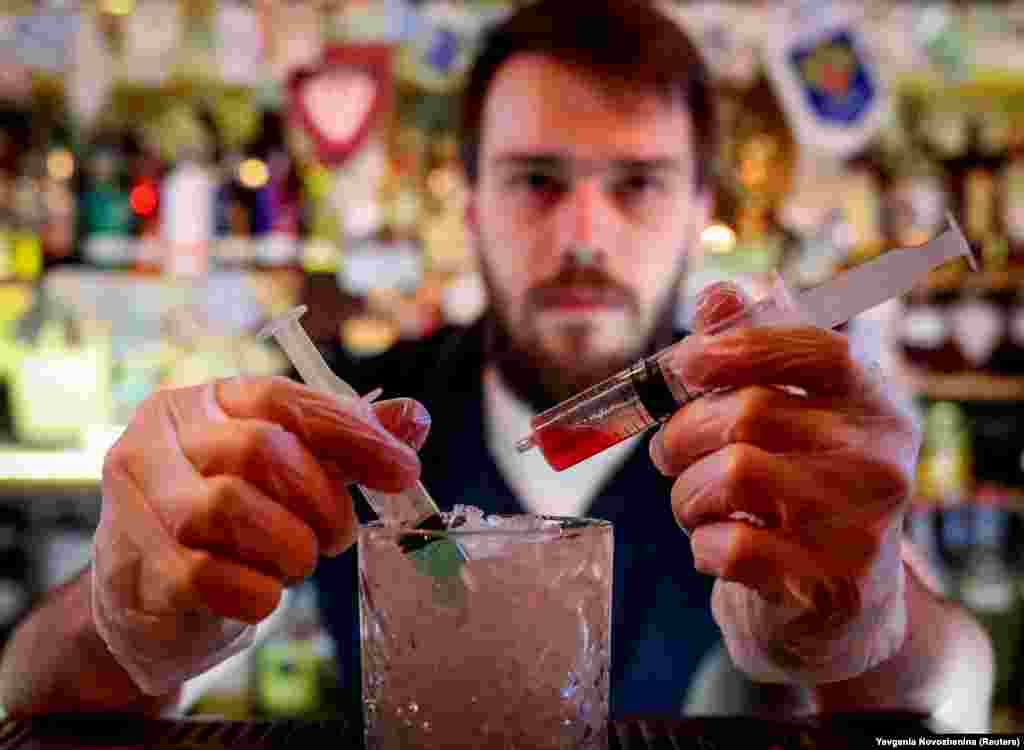 A Moscow barman prepares the newly invented Coronavirus Cocktail. The bartender refused to disclose the ingredients of the cocktail, which was named after the rapidly spreading virus that causes COVID-19.&nbsp;