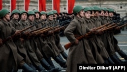 Russian servicemen dressed in historical uniforms march during a military parade on Red Square in Moscow on November 7, 2019.
