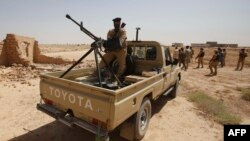 Iraqi troops monitor an area west of the shrine city of Karbala on June 29. In recent days, Iraqi forces have been pursuing a campaign to retake the militant-held city of Tikrit, clashing with Sunni fighters nearby and pounding positions inside the city with air strikes in their biggest counter-offensive to date. 