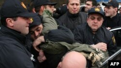 Police arrest war veterans staging a protest in Tbilisi.