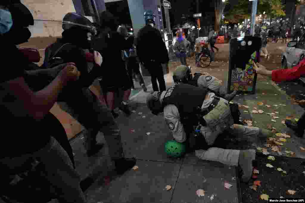 Oregon State Police arrest a protester in Portland, Ore., Wednesday, Nov. 4, 2020.