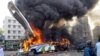 A bus is seen in flames at the site of a bomb explosion that killed six people in the Pakistani city of Karachi (Reuters)